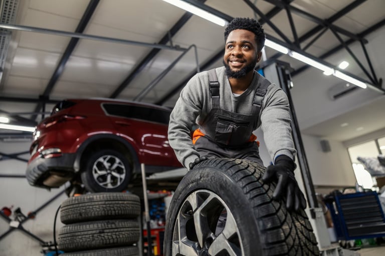 Car technician with tire